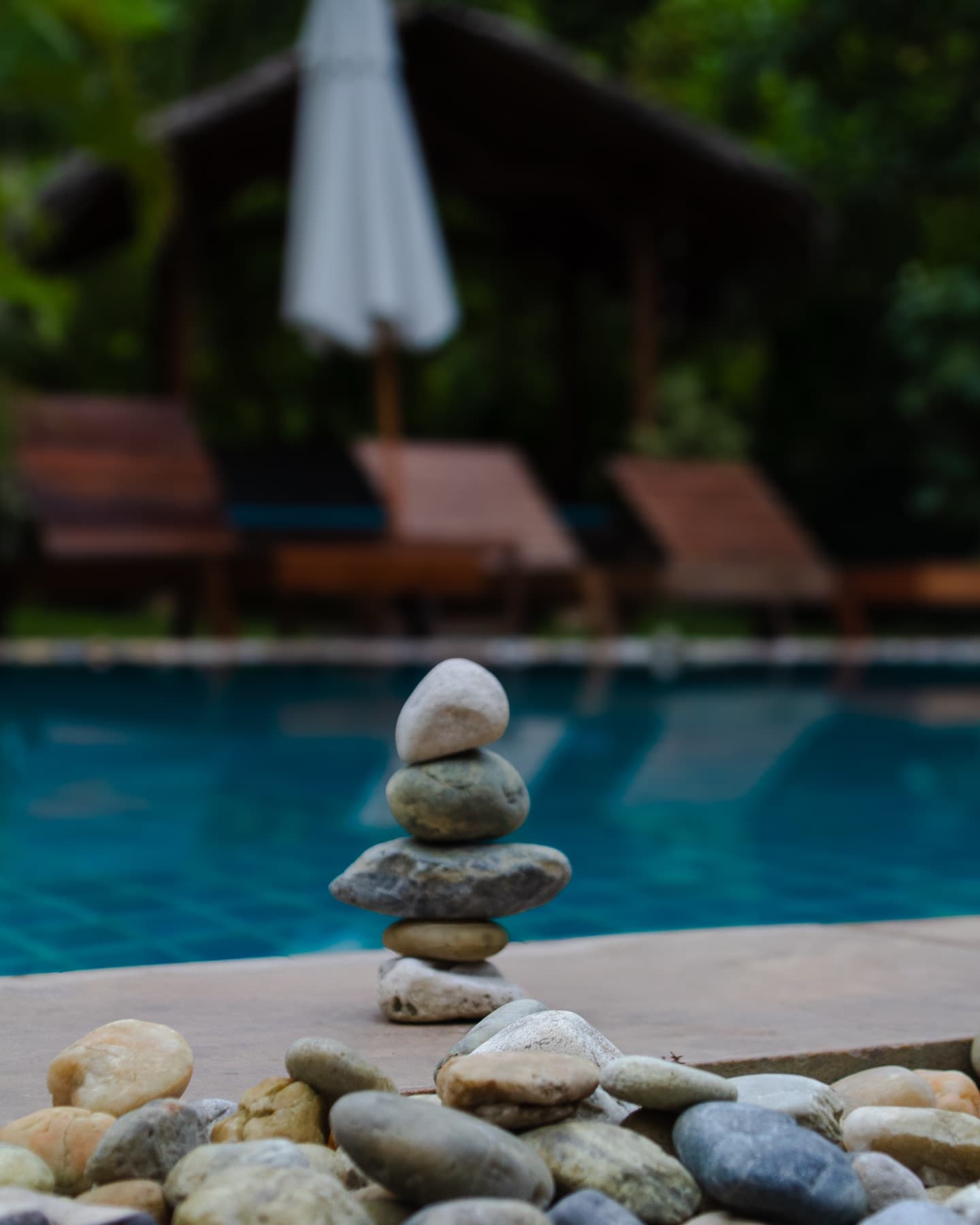 Balanced stones by the pool at Wonderland Healing Center