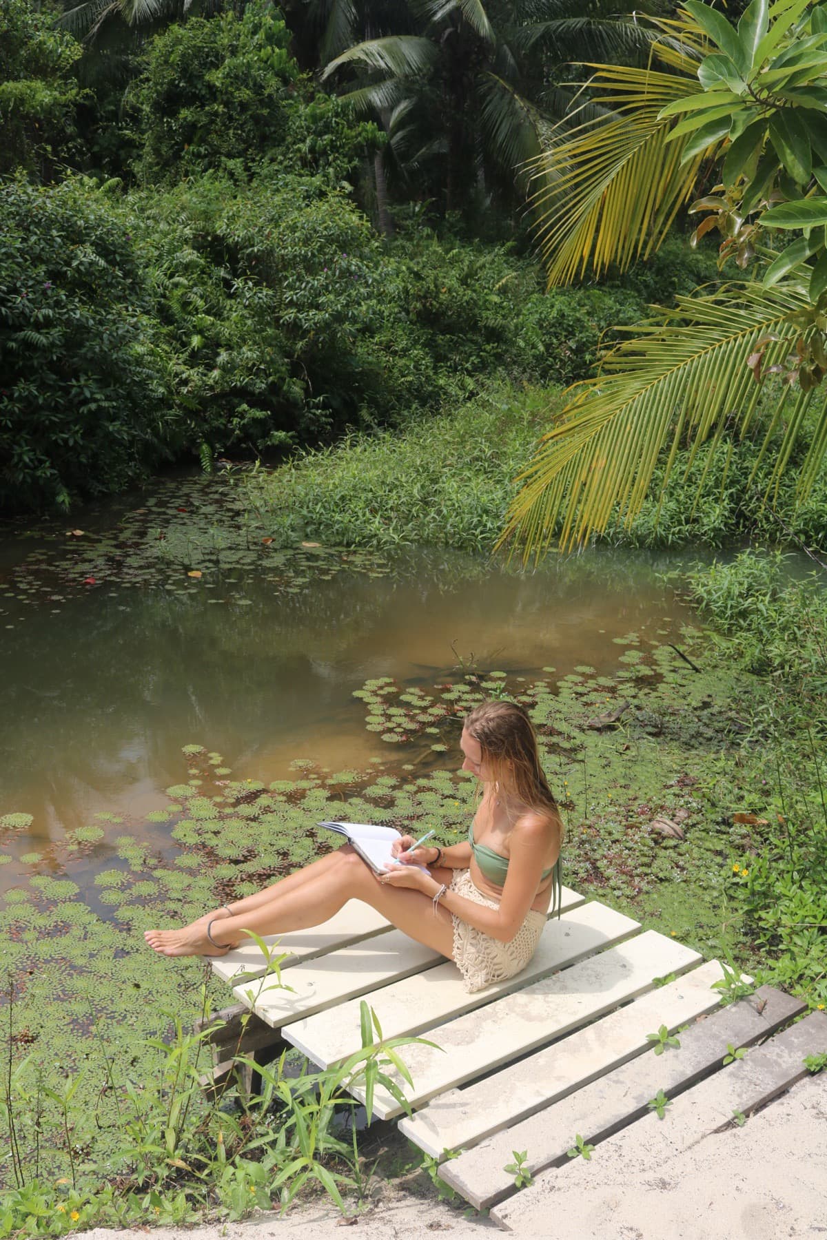 Guest relaxing by the pond at Wonderland Healing Center